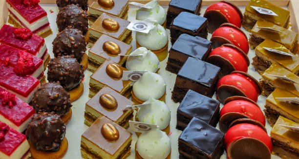 Assorted different mini cakes with cream, chocolate and berries-Sweets offered at the Moroccan wedding